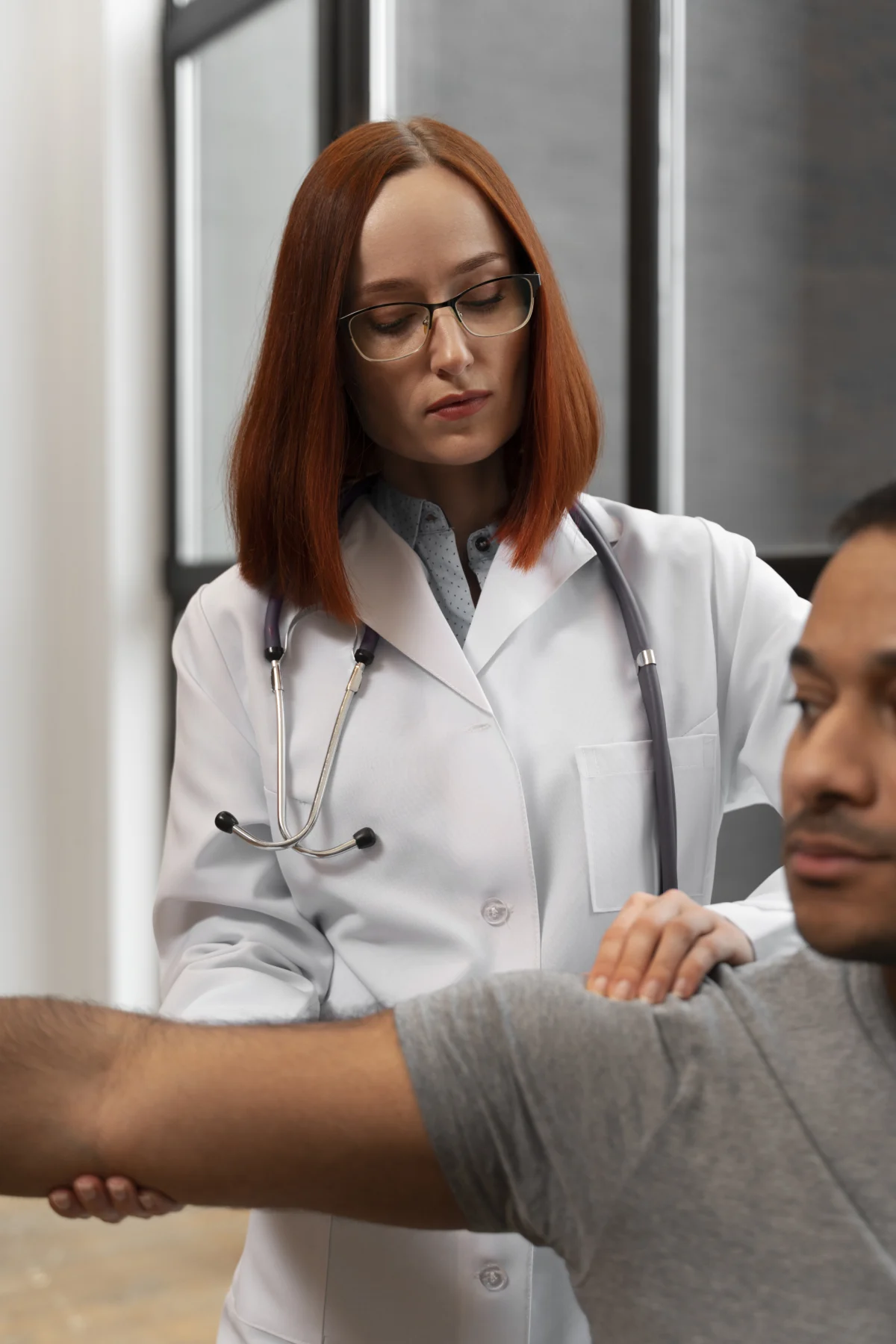 Naturopathic physician performing a shoulder exam during a functional medicine assessment at Divine Naturopathic Clinic in Kirkland, WA.